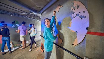 Student paints murals in underground tunnel