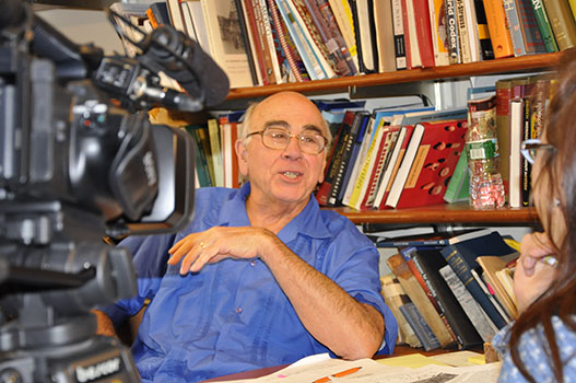 Tony Aveni talks with Fuji TV crew in his office.