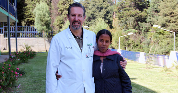 Eric Gokcen '84 stands with Workitu Debebe, his Ethiopian patient who had a "parasitic twin."