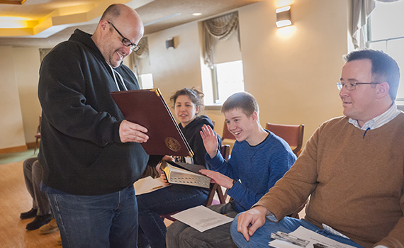 University chaplain Mark Shiner holds the Bible as James Buttner '15 takes an oath swearing that his votes in Colgate's Model papal conclave will not be influenced by outside parties.