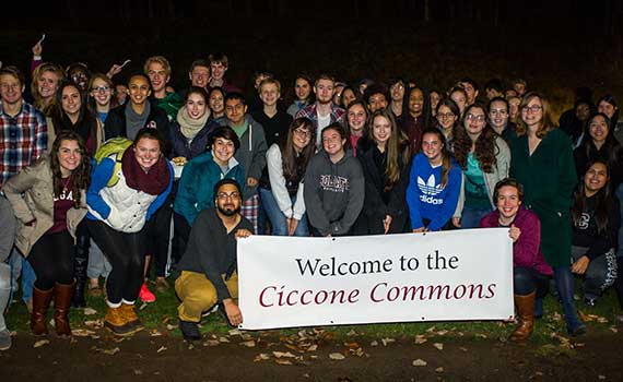 Students hold up a sign reading "Welcome to the Ciccone Commons"