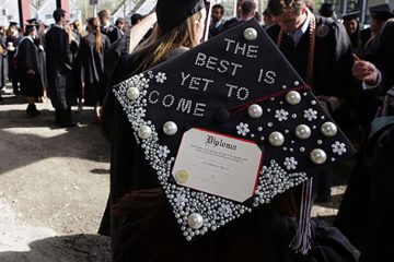 Glitter-adorned graduation cap that reads "The best is yet to come"
