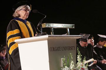 nterim President Jill Harsin stands at the podium in Sanford Field House during Commencement 2016 (Photo by Gerard Gaskin)