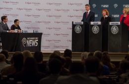 Three candidates for the 22nd Congressional District seat standing at podiums at the debate in the Memorial Chapel at Colgate University