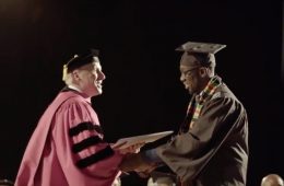 Student shaking hands with president at Commencement