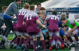 Soccer team piles up to celebrate