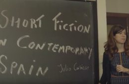 Marta Perez-Carbonell at a blackboard that reads Short Fiction in Contemporary Spain