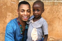 Uyi Omorogbe ’19 poses with child