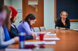 Peter Balakian, Donald M. and Constance H. Rebar Professor in humanities and professor of English, sits at a table with students