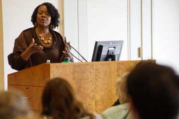 Professor Dianne Stewart ’90 lectures from a podium
