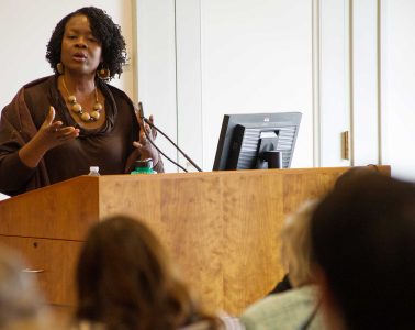 Professor Dianne Stewart ’90 lectures from a podium